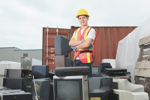 Workers preparing waste for recycling and documenting disposal